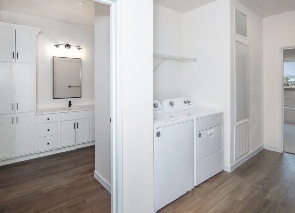 a white laundry room with white appliances and white cabinets at The Crossings  at Windsong, Prescott Valley, Arizona