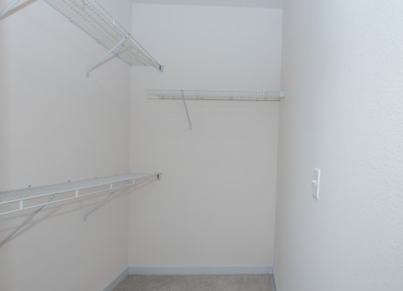 a room with a hanging rack on the wall and a closet at The Crossings  at Windsong, Prescott Valley, AZ