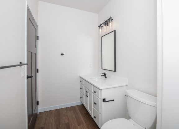 a white bathroom with a white toilet and a white sink at The Crossings  at Windsong, Arizona, 86314