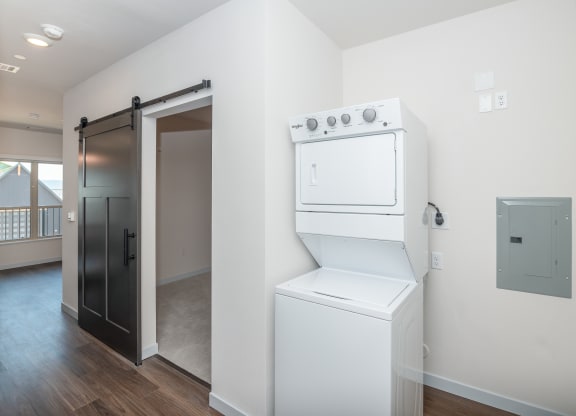 a white washer and dryer in a room with a door to a closet at The Crossings  at Windsong, Arizona