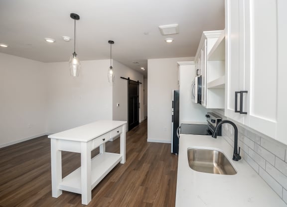 a kitchen with white cabinets and a sink and a counter top at The Crossings  at Windsong, Prescott Valley, 86314
