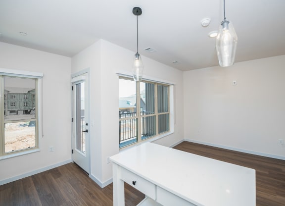 an empty living room with a white table and a window at The Crossings  at Windsong, Arizona, 86314