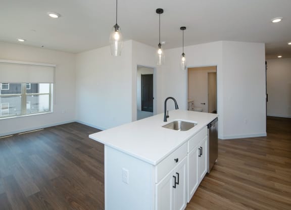 an empty kitchen with a white counter top in a new home at The Crossings  at Windsong, Prescott Valley, Arizona