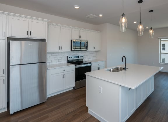 a kitchen with white cabinets and a white counter top at The Crossings  at Windsong, Prescott Valley, 86314