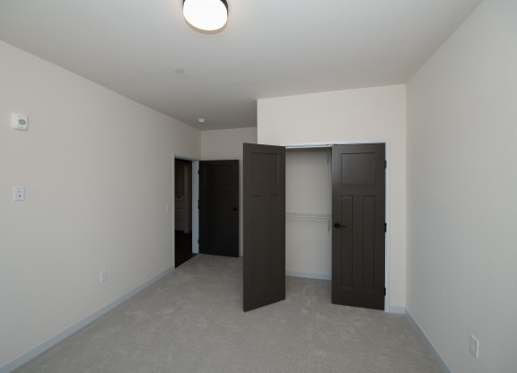 a bedroom with two doors and a closet at The Crossings  at Windsong, Prescott Valley