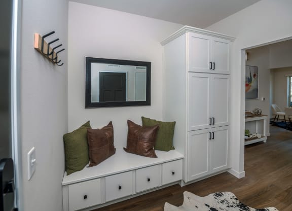 a living room with a couch and a mirror on the wall at The Crossings  at Windsong, Arizona
