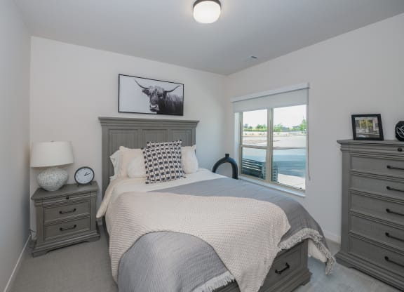 a large bedroom with a bed and a window at The Crossings  at Windsong, Prescott Valley, 86314