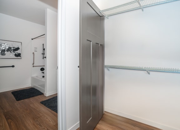 a closet in a room with white walls and wood floors at The Crossings  at Windsong, Arizona, 86314