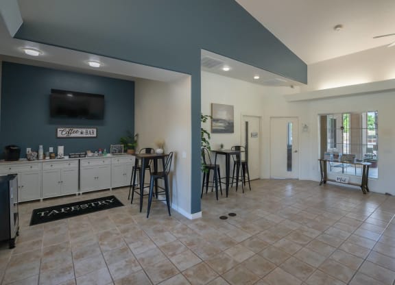 a clubhouse with a bar and a kitchen with stools