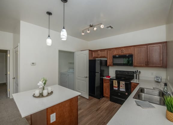 a kitchen with black appliances and a white counter top