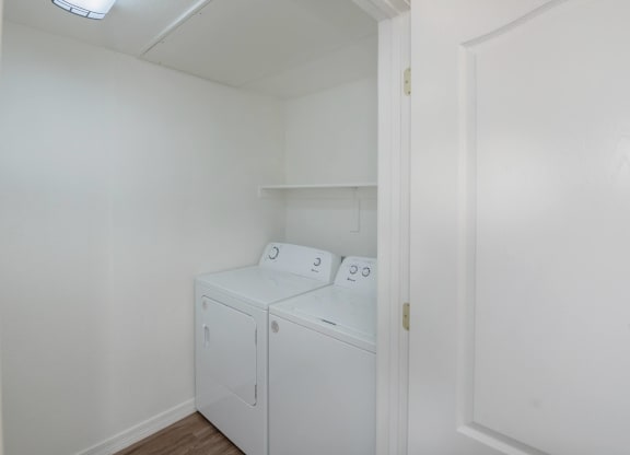 a small laundry room with a washer and dryer and white walls