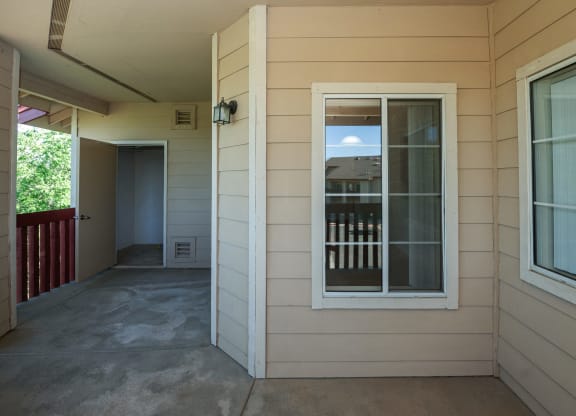a view of the front porch of a house with a window