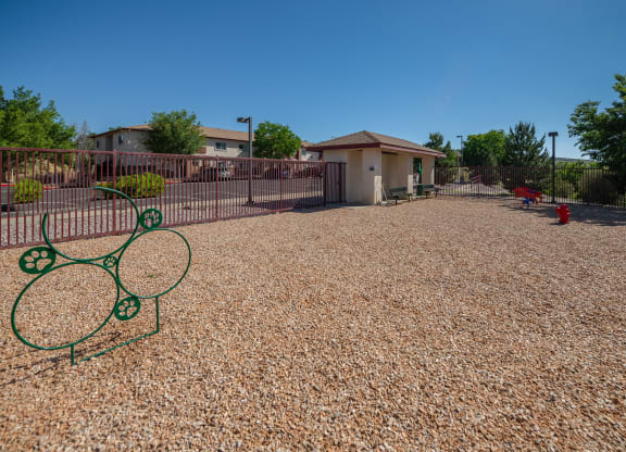 a tennis court with a tennis racket in front of a house