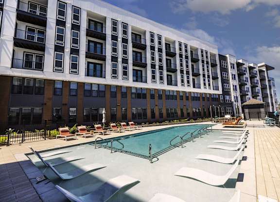 A large building with a pool in front.