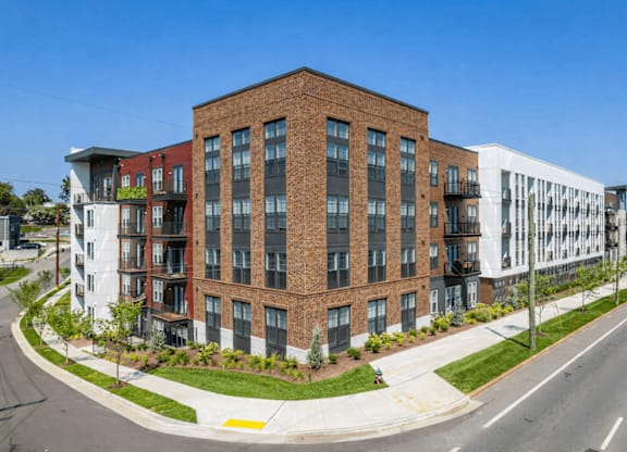 A modern multi-story building with a mix of brick and white exterior walls.