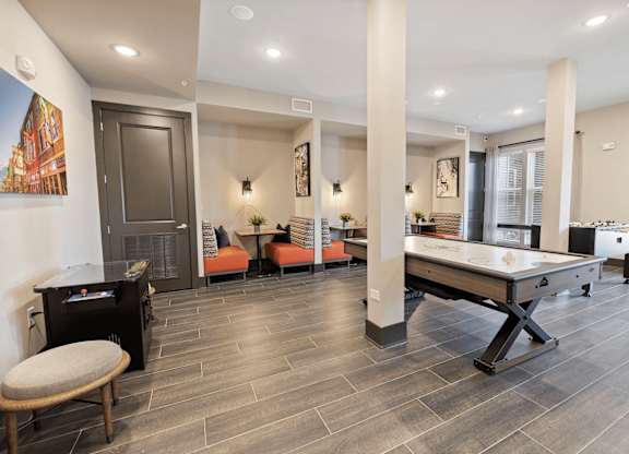 A room with a pool table and a fireplace.