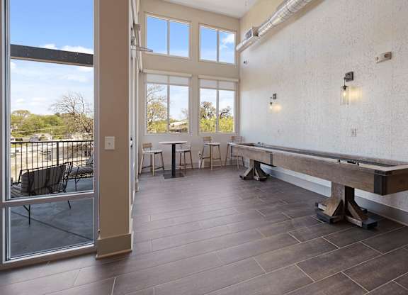 A room with a long bench and a table with chairs.