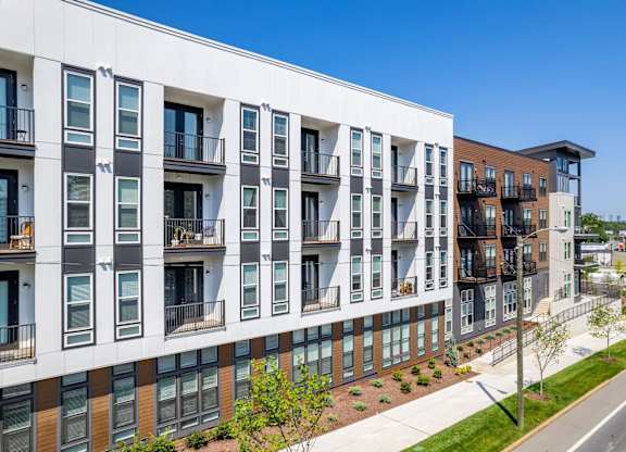 A modern apartment building with balconies and windows.