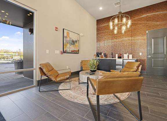 A living room with a brown leather chair and a white coffee table.
