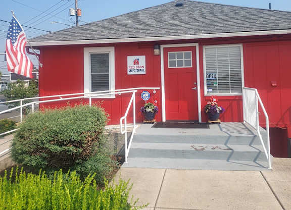 A red building with a sign that says "Self Storage" on it.