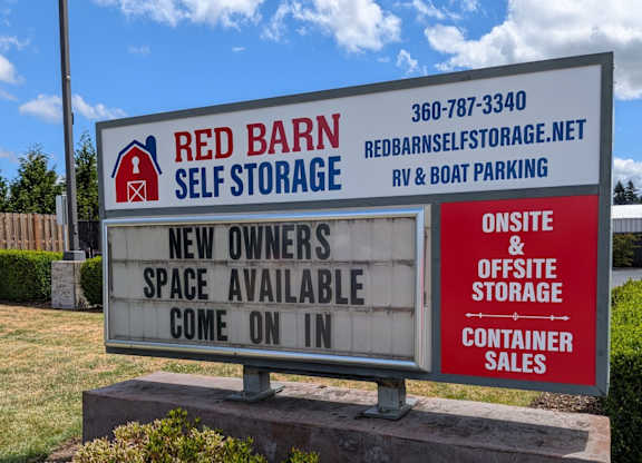 A sign for Red Barn Self Storage advertises new owner space availability.