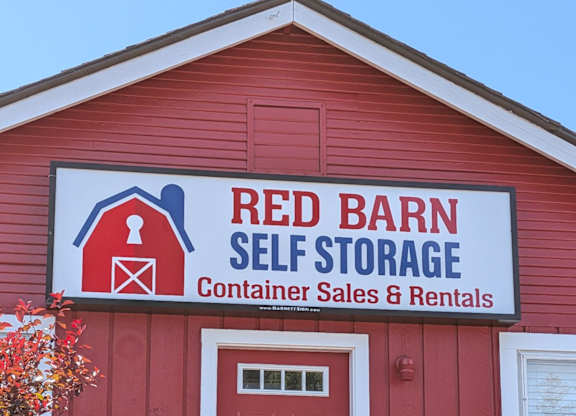 A red barn with a sign that says Red Barn Self Storage.
