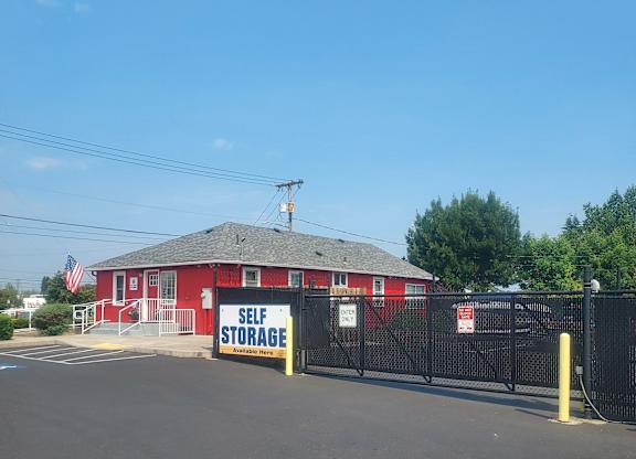 A red building with a sign that says "Self Storage".