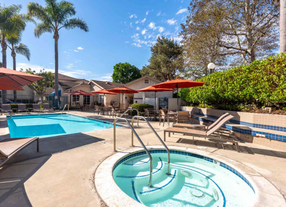 our apartments have a resort style pool with chairs and umbrellas