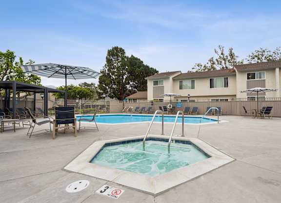 A pool with a hot tub in the middle of it.