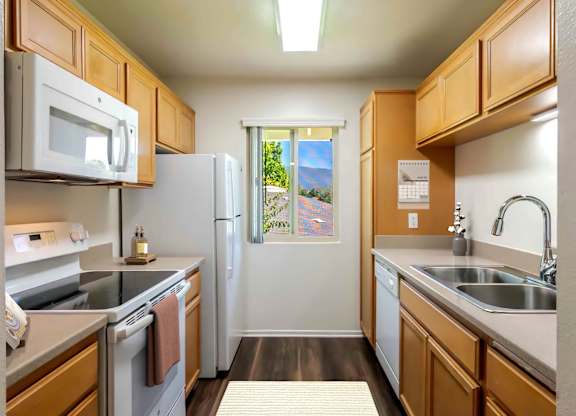 A kitchen with wooden cabinets and stainless steel appliances.