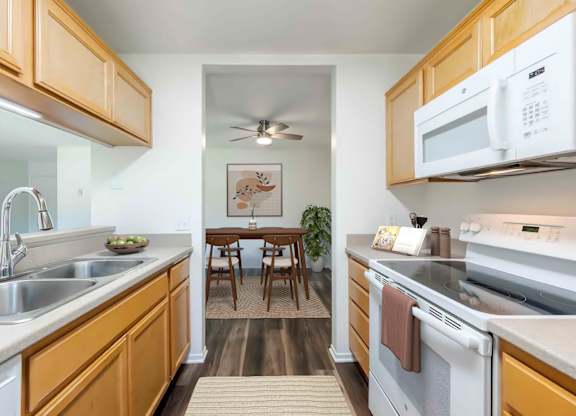 A kitchen with wooden cabinets and stainless steel appliances.