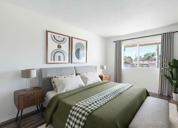 A bedroom with a large bed and a green blanket.