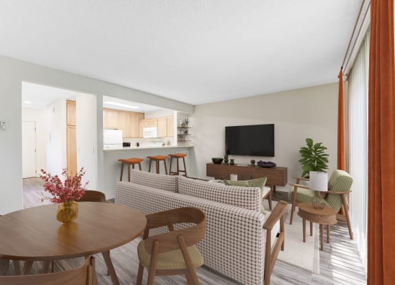 Goleta, CA, Apartments Near Starbucks - Encina Meadows - Living Room With Round Wood Table, Patterned Sofa, And Wall-Mounted Television.