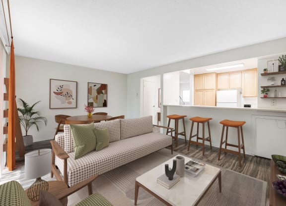 Goleta, CA Apartments Near Starbucks - Encina Meadows - Furnished Living Room with Plank Flooring, Area Rug, Sofa, Chairs, Coffee Table, and View of Dining Area and Kitchen.