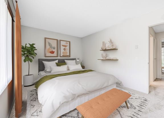 a bedroom with a white bedspread and green blanket