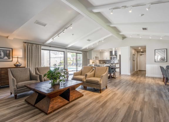 a living room with couches and chairs and a table