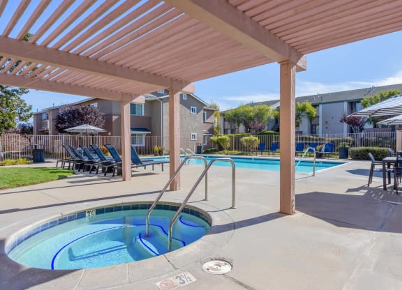 2-BR Apartments in Orcutt, CA - Knollwood Meadows - Poolside Hot Tub/Spa Under Pergola with Chairs, Tables, Lounge Chairs, And Umbrellas