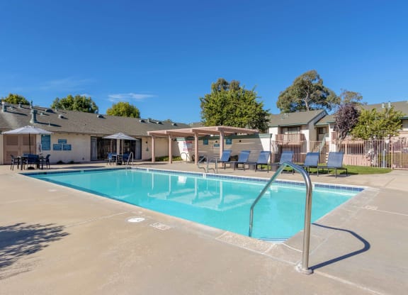 Pet-Friendly Apartments in Orcutt, CA - Knollwood Meadows - Sparkling Pool With Lounge Seats, Tables and Chairs with Umbrellas, Pergola, and Hot Tub