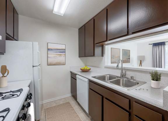 A kitchen with brown cabinets and a white stove.