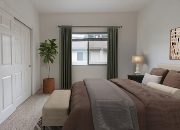 a bedroom with a bed and a window with green curtains
