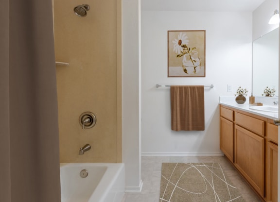 a bathroom with a shower and a sink and a mirror