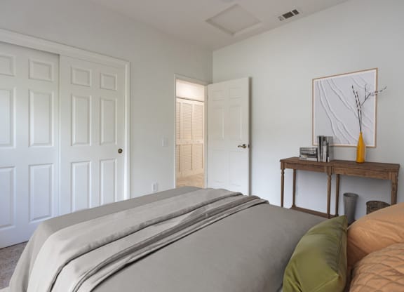 a bedroom with a bed and a door to a bathroom