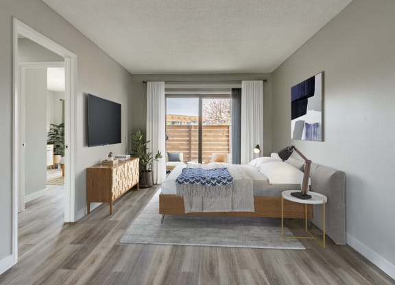 a bedroom in an apartment with a bed and a tv