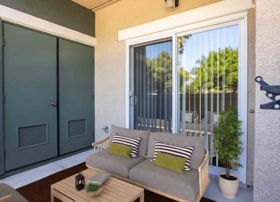 a patio with a couch and a patio door