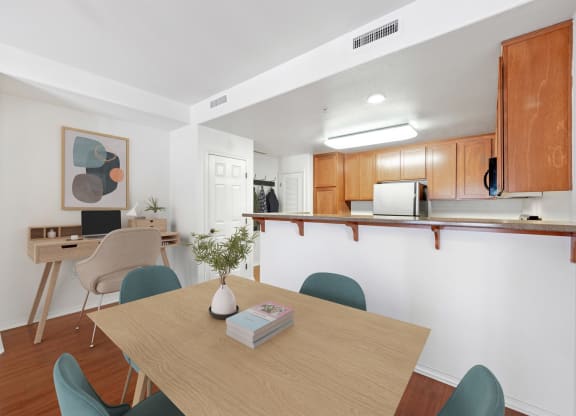 a dining room and kitchen with a table and chairs