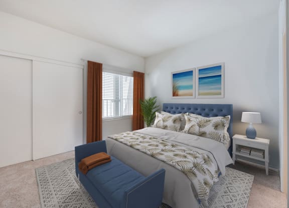 a bedroom with a large bed with a blue chaise lounge at the foot of the bed