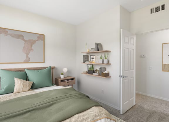 a bedroom with white walls and green bedding