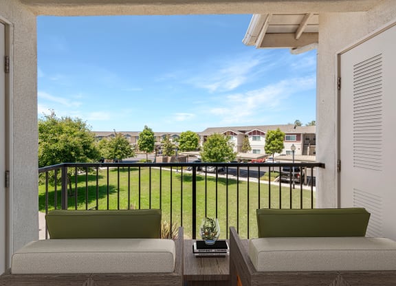 a balcony with two couches and a coffee table