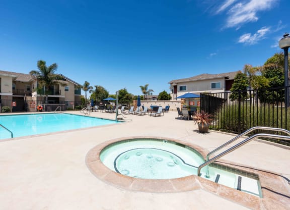 Santa Maria, CA, Apartments Near Vandenberg Air Force Base - Siena - Gated Pool with Hot Tub, Lounge Seats, Tables, Chairs, and Umbrellas