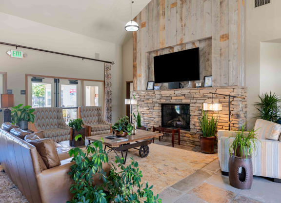 a living room with couches a coffee table and a fireplace